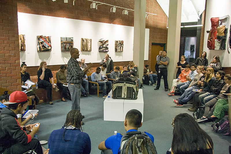 Charles McGill speaks to students, staff and faculty at opening reception for Cross Section at the NCC Art Gallery in 2012