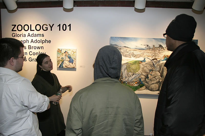 Artist Gloria Adams speaking with NCC students at the Zoology 101 opening at the NCC Art Gallery